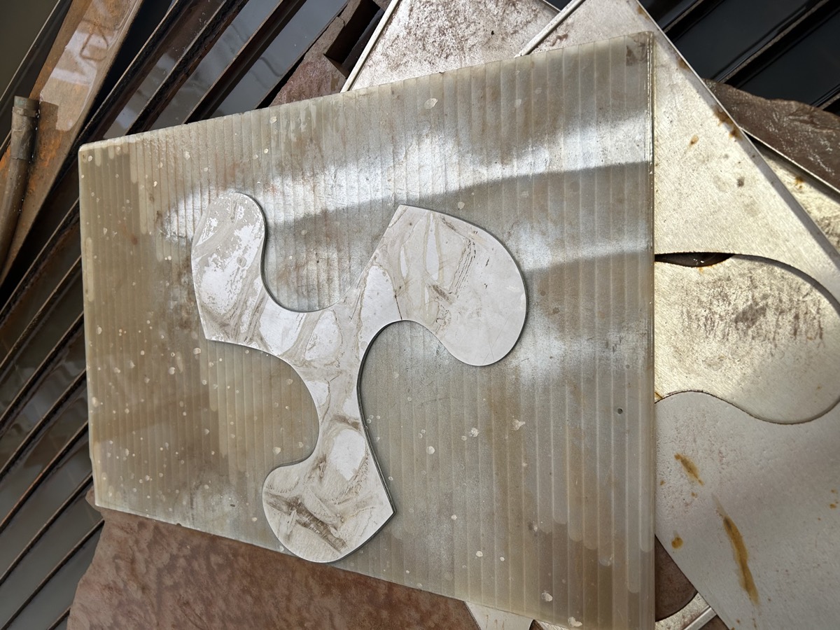 Organic shape cut in marble tile